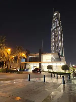a large building with a tall skyscraper in the background at Burj Dubai Area - 5min Walk - Luxury 2 Bedroom Apartment in Dubai