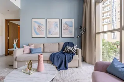 a living room with a couch and a table at GuestReady - Deluxe Waterfront View in the Marina in Dubai