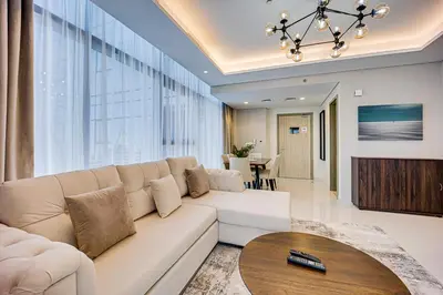 a living room with a white couch and a table at Luxury 2 Bedroom in Paramount Midtown Residence in Dubai