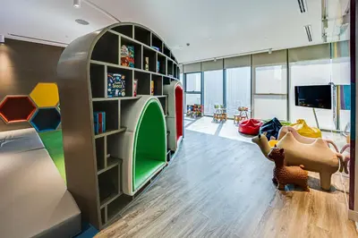 a childrens room with a play area with a book shelf at Luxury 2 Bedroom in Paramount Midtown Residence in Dubai
