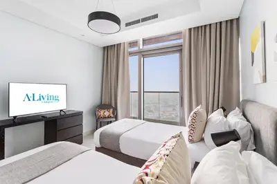 a hotel room with two beds and a tv at ALiving Luxe 2BR with higest Infinity Pool Close to Dubai Mall & Burj Khalifa in Dubai