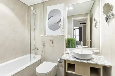 a bathroom with a sink and a toilet and a tub at ALiving Luxe 2BR with higest Infinity Pool Close to Dubai Mall & Burj Khalifa in Dubai