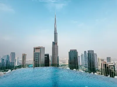 a swimming pool on the roof of a building with a city at ALiving Luxe 2BR with higest Infinity Pool Close to Dubai Mall & Burj Khalifa in Dubai