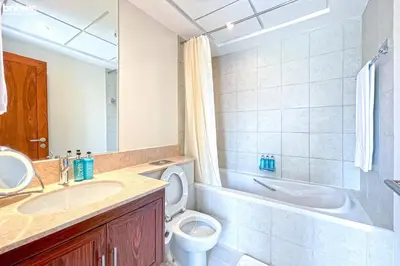 a bathroom with a sink and a toilet at bnbme - Luxury 2BR Near Burj Khalifa Apt Balcony Pool Gym Concierge Near Dubai Mall in Dubai