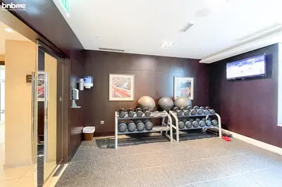 a gym with a bunch of balls on a wall at bnbme - Luxury 2BR Near Burj Khalifa Apt Balcony Pool Gym Concierge Near Dubai Mall in Dubai
