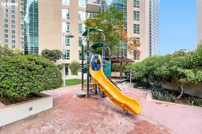 a slide in a playground in a city at bnbme - Luxury 2BR Near Burj Khalifa Apt Balcony Pool Gym Concierge Near Dubai Mall in Dubai