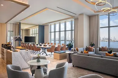 a lobby with couches and a table and chairs at Address Creek Harbour in Dubai