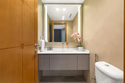 a bathroom with a sink and a mirror at The Smart Concierge - Marina Scape in Dubai