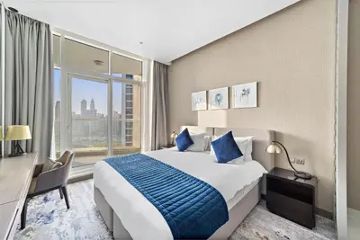 a hotel room with a bed and a large window at ALiving Luxury Studio with Canal Views I DAMAC Maison Prive 2512 in Dubai