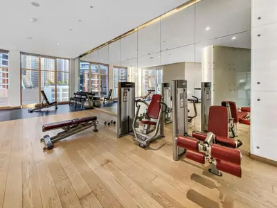 a gym with several exercise equipment in a room at ALiving Luxury Studio with Canal Views I DAMAC Maison Prive 2512 in Dubai