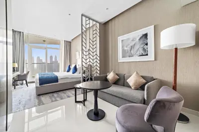 a living room with a couch and a bed at ALiving Luxury Studio with Canal Views I DAMAC Maison Prive 2512 in Dubai