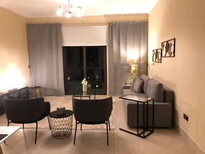 a living room with a couch and chairs at Luxury 3 Bedroom Apartment - DUBAI MALL 5 min Walk in Dubai