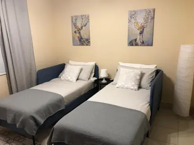 two beds sitting next to each other in a room at Luxury 3 Bedroom Apartment - DUBAI MALL 5 min Walk in Dubai