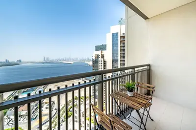 a balcony with a bench and a view of the ocean at Panoramic Burj Views - Lovely 3BR in Creek Harbour in Dubai