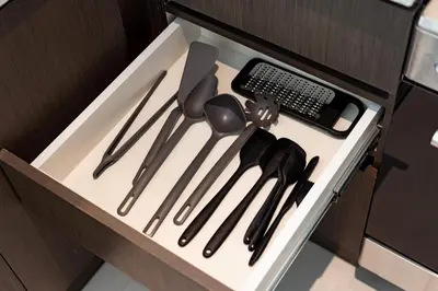 a drawer filled with cooking utensils and a keyboard at Panoramic Burj Views - Lovely 3BR in Creek Harbour in Dubai