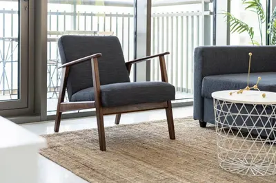 a chair and a couch in a living room at Panoramic Burj Views - Lovely 3BR in Creek Harbour in Dubai