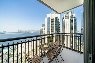 a balcony with chairs and a view of the city at Panoramic Burj Views - Lovely 3BR in Creek Harbour in Dubai