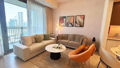 a living room with a couch and a table at Lovely 1BD canal view apartment in Dubai Marina in Dubai
