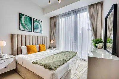 a bedroom with a large bed and a large window at Lovely 1BD canal view apartment in Dubai Marina in Dubai