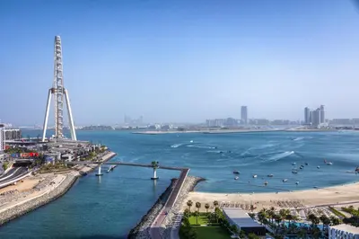 a body of water with a beach and a city at Lovely 1BD canal view apartment in Dubai Marina in Dubai