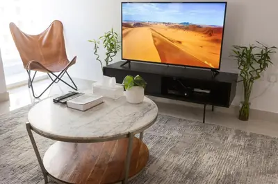 a living room with a coffee table and a tv at Enticing space With Marina View Near the Beach! in Dubai