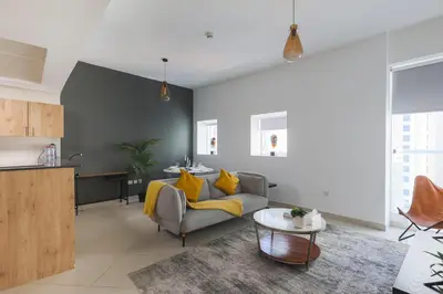 a living room with a couch and a table at Enticing space With Marina View Near the Beach! in Dubai