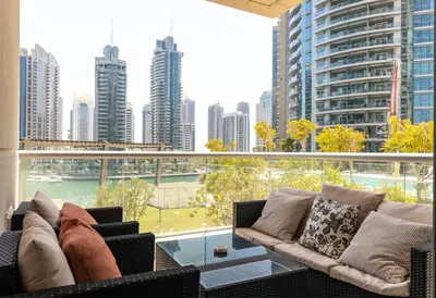 a balcony with couches and a view of a city at Dubai Marina, Two bedrooms apartment with full Marina View in Dubai