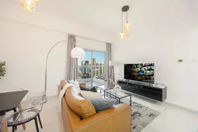 a living room with a couch and a table at Stunning Space with Full Marina View in Dubai