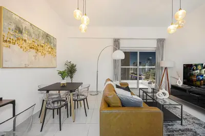 a living room with a couch and a table at Stunning Space with Full Marina View in Dubai