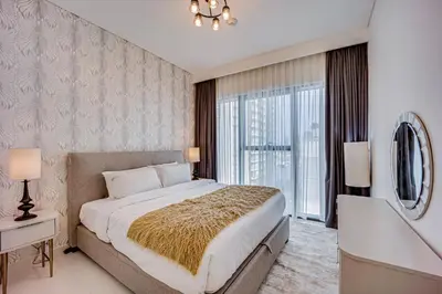 a bedroom with a large bed and a large window at Lovely 1 BD apartment in Beach Vista Tower in Dubai