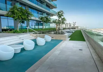 a view from the roof of a building with white benches at Lovely 1 BD apartment in Beach Vista Tower in Dubai