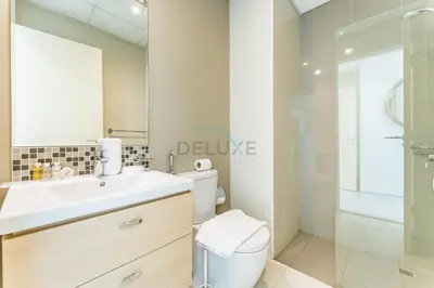 a bathroom with a sink and a toilet and a shower at Flawless 3BR Townhouse with Assistant's Room at DAMAC Hills 2 by Deluxe Holiday Homes in Dubai