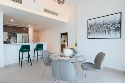 a dining room with a table and chairs at HiGuests - Spacious Apt Near Zabeel Park With Panoramic Views in Dubai