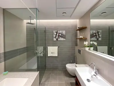 a bathroom with a shower and a toilet and a sink at HiGuests - Spacious Apt Near Zabeel Park With Panoramic Views in Dubai