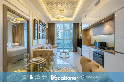 a room with a kitchen and a living room at Studio One - Beautiful One Bedroom in Dubai