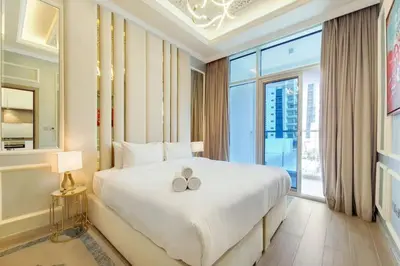 a bedroom with a large bed and a large window at Studio One - Beautiful One Bedroom in Dubai