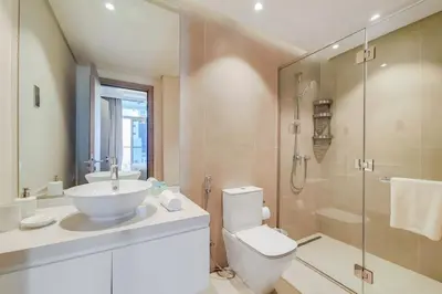 a bathroom with a toilet and a sink and a shower at Studio One - Beautiful One Bedroom in Dubai