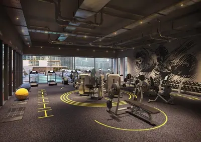 a gym with exercise equipment and a mural on the wall at Studio One - Beautiful One Bedroom in Dubai