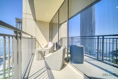 a balcony with chairs and a view of the city at Peaceful 1BR at Creek Rise Tower 2 Dubai Creek Harbour by Deluxe Holiday Homes in Dubai