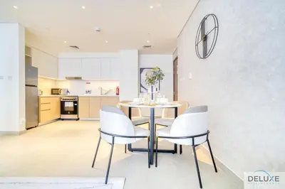 a kitchen and dining room with a table and chairs at Peaceful 1BR at Creek Rise Tower 2 Dubai Creek Harbour by Deluxe Holiday Homes in Dubai