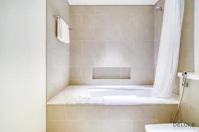 a bath tub in a bathroom with a shower at Peaceful 1BR at Creek Rise Tower 2 Dubai Creek Harbour by Deluxe Holiday Homes in Dubai