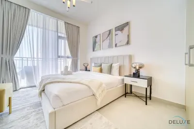 a white bedroom with a bed and a window at Peaceful 1BR at Creek Rise Tower 2 Dubai Creek Harbour by Deluxe Holiday Homes in Dubai