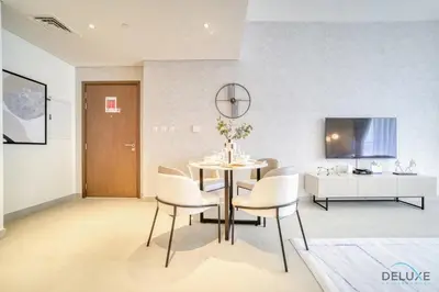 a dining room with a table and chairs at Peaceful 1BR at Creek Rise Tower 2 Dubai Creek Harbour by Deluxe Holiday Homes in Dubai