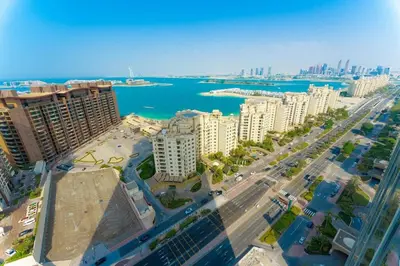 an aerial view of a city with buildings and water at FAM Living - Palm Tower - Palm Jumeirah - Panoramic Studios in Dubai