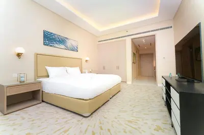 a large bedroom with a large bed and a television at FAM Living - Palm Tower - Palm Jumeirah - Panoramic Studios in Dubai