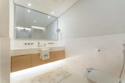 a bathroom with a sink and a toilet and a mirror at FAM Living - Palm Tower - Palm Jumeirah - Panoramic Studios in Dubai