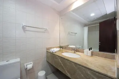 a bathroom with a sink and a mirror at RH- Lovely 1BR apartment in JLT, near metro in Dubai
