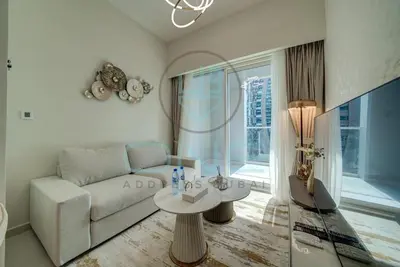 a living room with a couch and a table at Elegant 1BR with Sofa Bed Close to Metro in Dubai