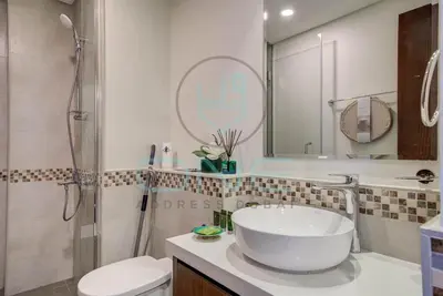 a bathroom with a sink and a shower and a toilet at Elegant 1BR with Sofa Bed Close to Metro in Dubai