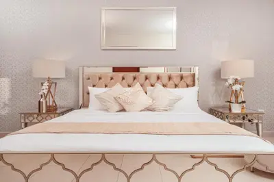 a bedroom with a large white bed with two lamps at Elite Royal Apartment - Panoramic Full Burj Khalifa, Fountain & Skyline view - Baron in Dubai